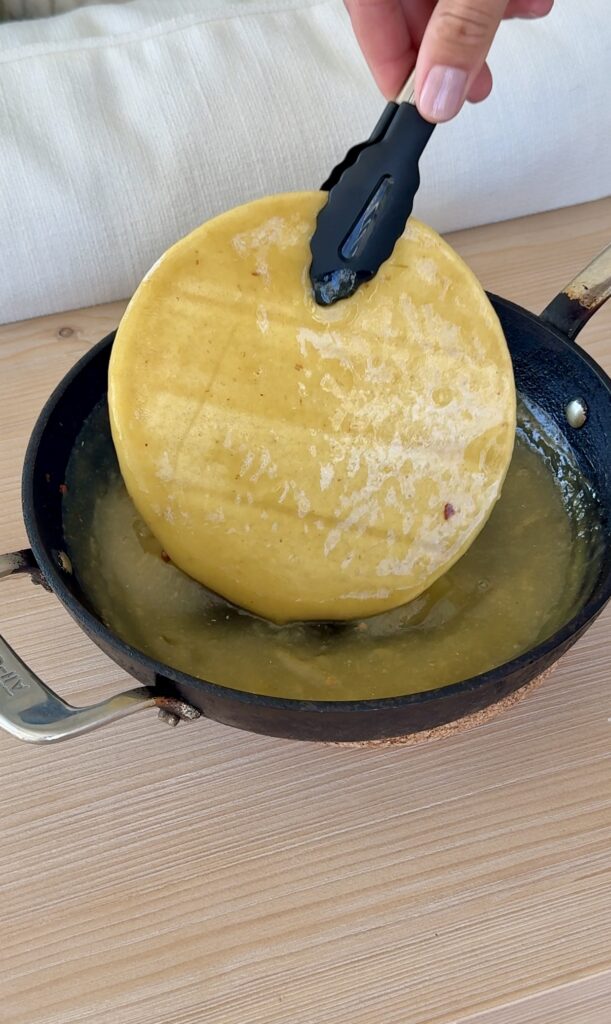 Chicken Enchiladas: Dip the corn tortillas in green enchilada sauce